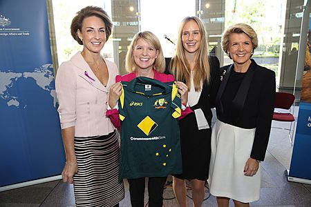 Perry poses for a photo next to the Minister for Foreign Affairs, Julie Bishop (right), after presenting an autographed Australian women's cricket team shirt to the Ambassador for Women & Girls, Natasha Stott Despoja (left).