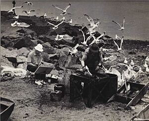 Gallagher (in white hat) painting on Monhegan Island, Maine