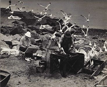 Gallagher (in white hat) painting on Monhegan Island, Maine