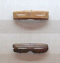 Inuit Snow goggles from Alaska. Made from carved wood, 1880-1890CE (top) and Caribou antler 1000-1800 CE (bottom)