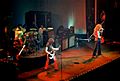 A color photograph of the band Led Zeppelin on stage