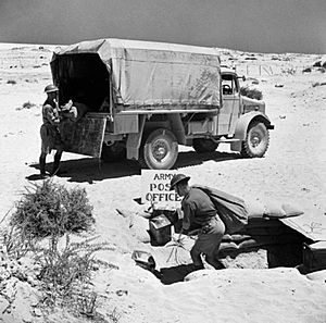 Mail being unloaded from an Army Post Office lorry in the Western Desert, 16 July 1941. E4175
