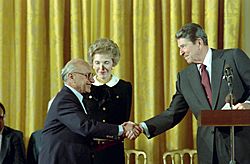 President Ronald Reagan and Nancy Reagan in The East Room Congratulating Milton Friedman Receiving The Presidential Medal of Freedom