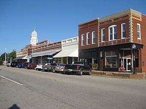 Broad Street storefronts in downtown Crawfordville, Georgia, with Taliaferro County Courthouse in the distance