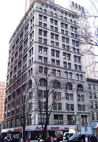 The eastern facade of the Mutual Reserve Building, seen from Duane Street during the winter. There are trees in the foreground.