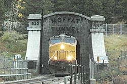 A diesel locomotive emerging from tunnel
