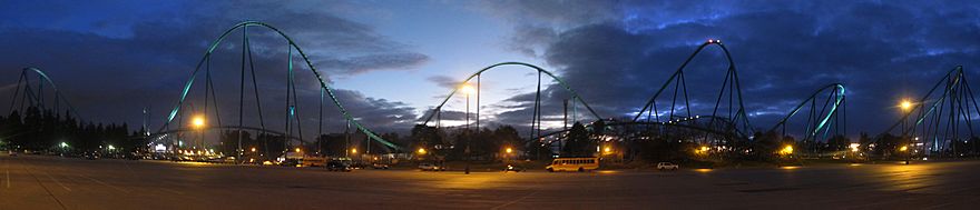 View of Leviathan roller coaster from a parking lot at dusk.