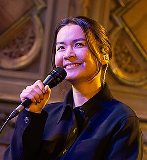 Mitksi smiling while holding a microphone.