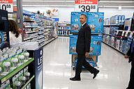 President Barack Obama walks through the aisles at Walmart