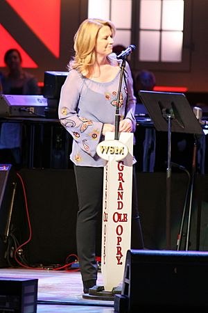 Country music artist Patty Loveless singing into a microphone