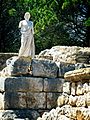 Reproduction of the statue of Aesclepius on the remains of a Greek rampart in the ancient city of Neapolis at the archaeological site of Empúries