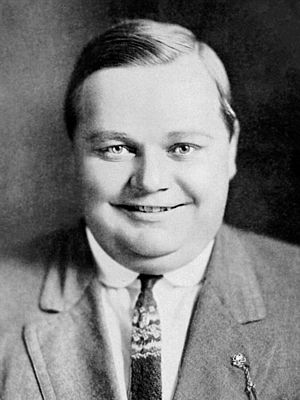 Arbuckle smiling in a suit