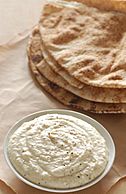 A bean dip prepared with white beans and Parmesan cheese, served with pita bread