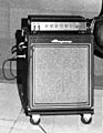 A 1950s era amplifier unit sitting on top of a bass speaker cabinet.