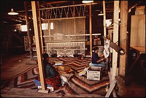 NAVAJO WOMEN WEAVE A RUG AT THE HUBBEL TRADING POST, FIRST TRADING POST ON THE NAVAJO RESERVATION - NARA - 544416