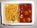 Ready to eat microwave food (TV dinner) Currywurst with French fries