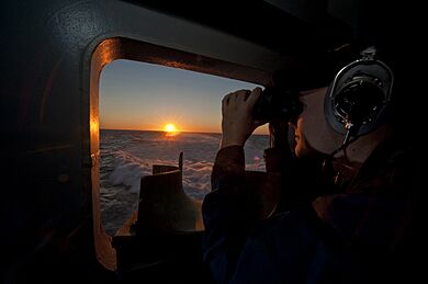 A Sailor stands watch aboard USS George H.W. Bush.
