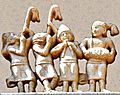 Foreigners in Greek dress playing carnyxes and aolus flute at Sanchi