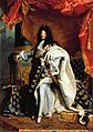 Formal full-length portrait of Louis XIV wearing long curling black wig and state robes including a cloak embroidered with golden fleur de lys.