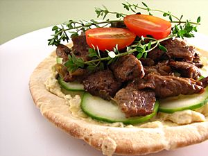 Pita topped with artichoke hummus and lamb