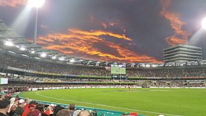 The Eastern end of The Gabba at sunset during an AFL game