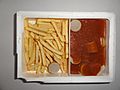 Frozen microwave food (TV dinner) Currywurst with French fries