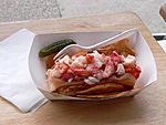 Lobster roll, with potato chips and a pickle