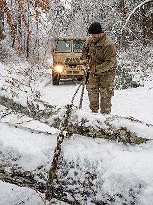 West Virginia National Guard members conduct road clearing and debris removal operations