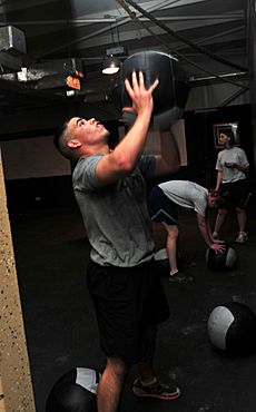 Soldier tosses a medicine ball while working out DVIDS462753