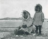 Eskimos woman and girl ice fishing