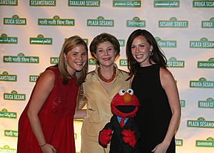 Mrs. Laura Bush and daughters pose for a photo with Sesame Street character Elmo