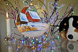 See through painted Christmas bauble on stand