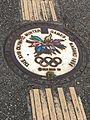 Stylized Nagao Olympics manhole cover with tactile paving