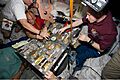 STS-129 crew members gather for a meal at the galley in the Unity node of the International Space Station