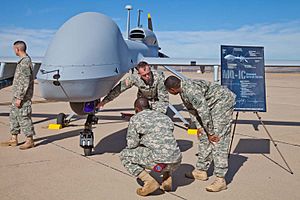 Soldiers from E Company, 160th Special Operations Aviation Regiment (Airborne), explain the capabilities of the MQ-1C Gray Eagle Unmanned Aircraft System at their activation ceremony Nov. 19, 2013.