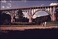 OHIO HIGHWAY 82 BRIDGE SPANS THE CUYAHOGA VALLEY AND THE OHIO-ERIE CANAL BEYOND THE WALKERS, NEAR CLEVELAND, OHIO.... - NARA - 557969
