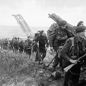 Royal Marine Commandos attached to 3rd Division move inland from Sword Beach on the Normandy coast, 6 June 1944. B5071