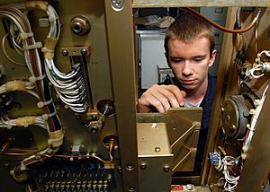 US Navy 080820-N-9079D-007 Electronics Technician 3rd Class Michael J. Isenmann, from St. Louis, Mo., performs a voltage check on a power circuit card in Air Navigation Equipment room aboard the aircraft carrier USS Abraham Lin