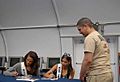 Miss USA contestants give autographs while visiting Guantanamo