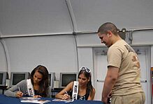Miss USA contestants give autographs while visiting Guantanamo