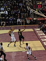 A basketball player misses a shot.