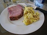A thick-cut ham steak and scrambled eggs