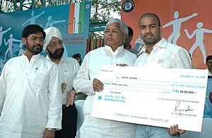 Lalu Prasad presenting a cheque of Rs. thirty lacs to Shri Akhil Kumar at the opening ceremony of the 56th Senior National Kabaddi (Men & Women) Championship being organized by Railway Sports Promotion Board from 11th to