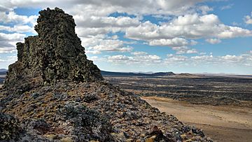 A pile of slag-like rocks above a treeless landscape