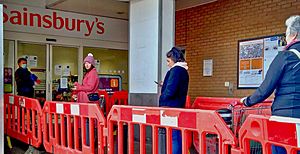 Social distancing queueing for the supermarket J. Sainsbury's north London Coronavirus Covid 19 pandemic - 30 March 2020