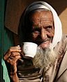 Old Bangladeshi drinking tea cropped