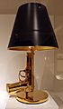 Philippe starck per flos spa., lampada bedside gun, con una pistola beretta placcata in oro, 2005