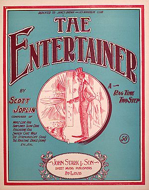 The front cover of "The Entertainer"'s sheet music. It has a green background and in the center is a red ink drawing of a caricatured African-American performer on stage in top hat and tails