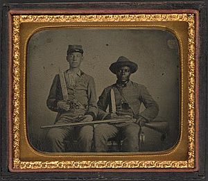 Sergeant A.M. Chandler of the 44th Mississippi Infantry Regiment, Co. F., and Silas Chandler, family slave, with Bowie knives, revolvers, pepper-box, shotgun, and canteen