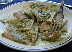 A plate of testaroli with pesto, as served at a trattoria in Pontremoli, Italy